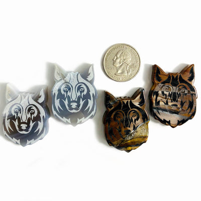 4 Gemstone Wolf Slices next to a quarter for size reference