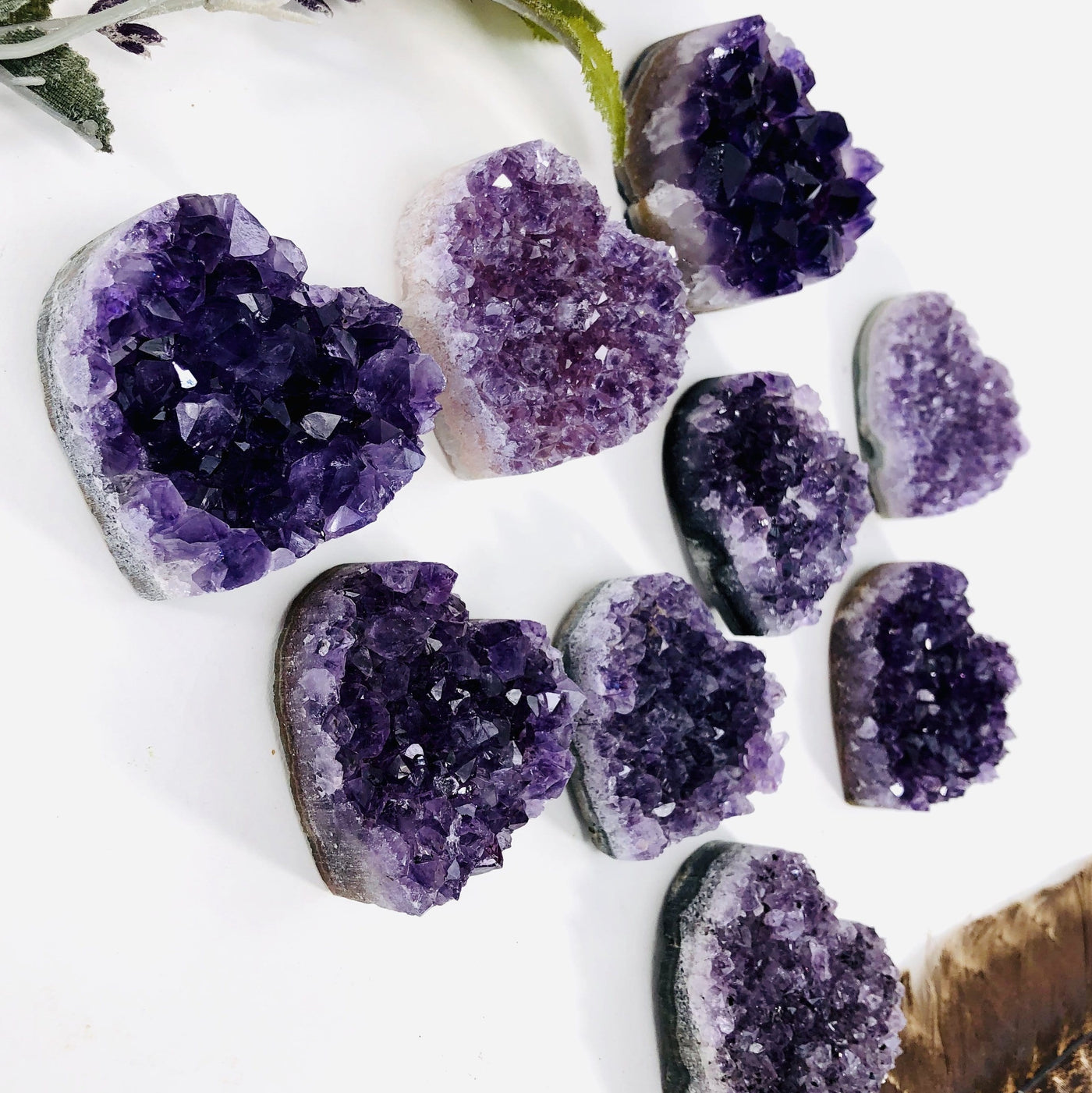 angled shot of amethyst hearts with decorations in the background