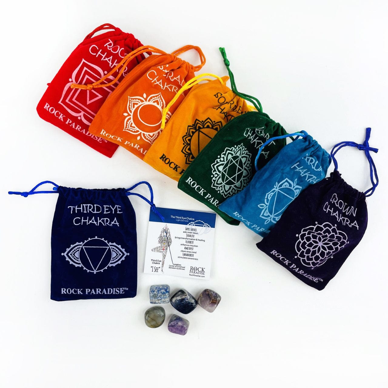 Third Eye Pouch opened with the information card and tumbled stones beside it, and the other sets behind
