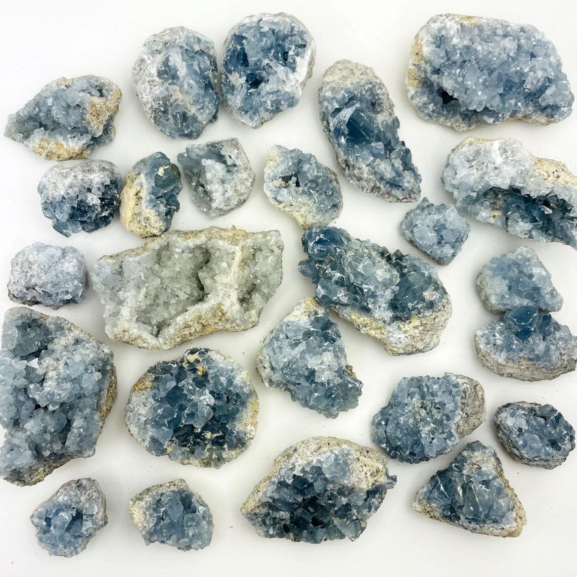 Celestite Crystals on a table in varying sizes