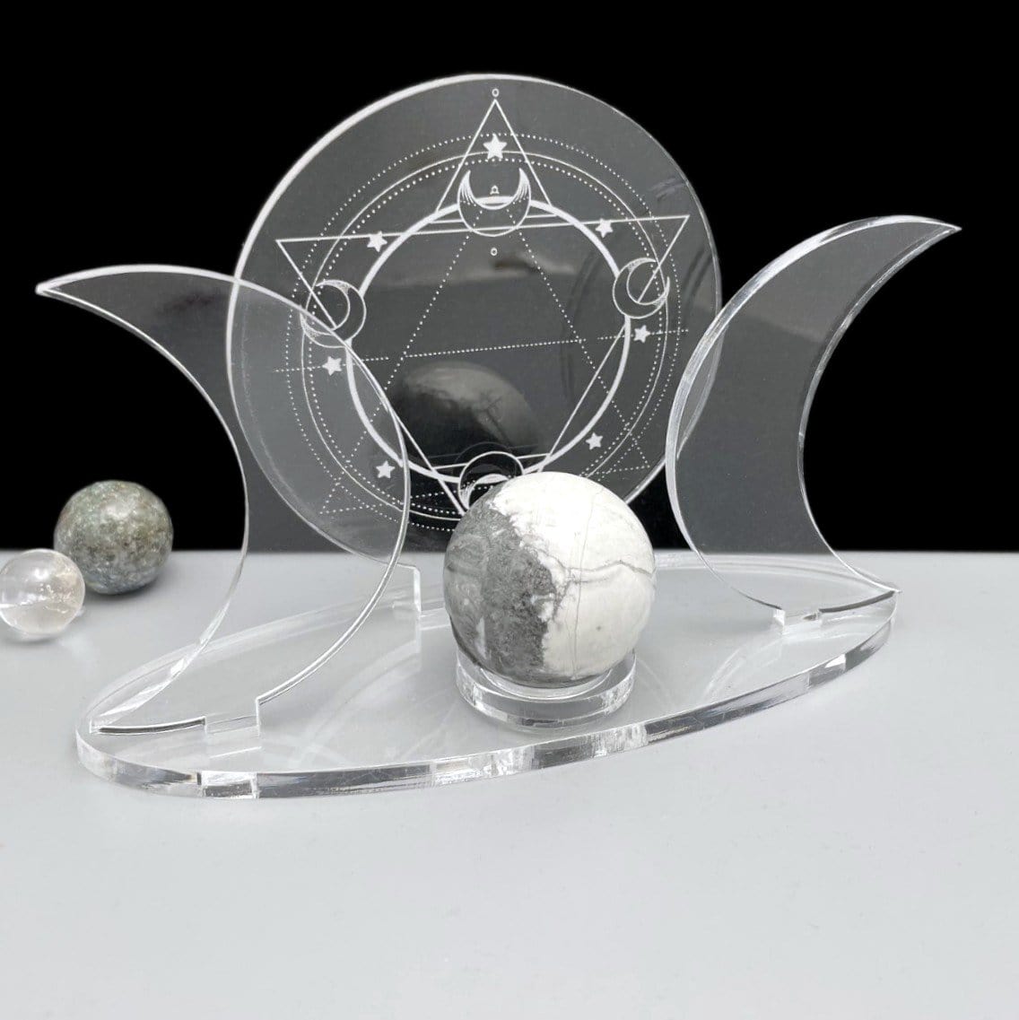 An Acrylic Sphere Holder Crescent Moons - Six Pointed Star in an alter surrounded with smaller spheres for display.