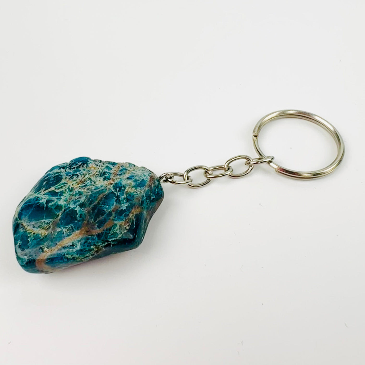 up close shot of apatite silver toned keychain on white background