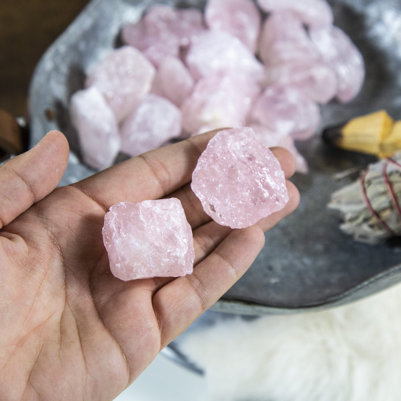 rose quartz stones in hand for size reference 