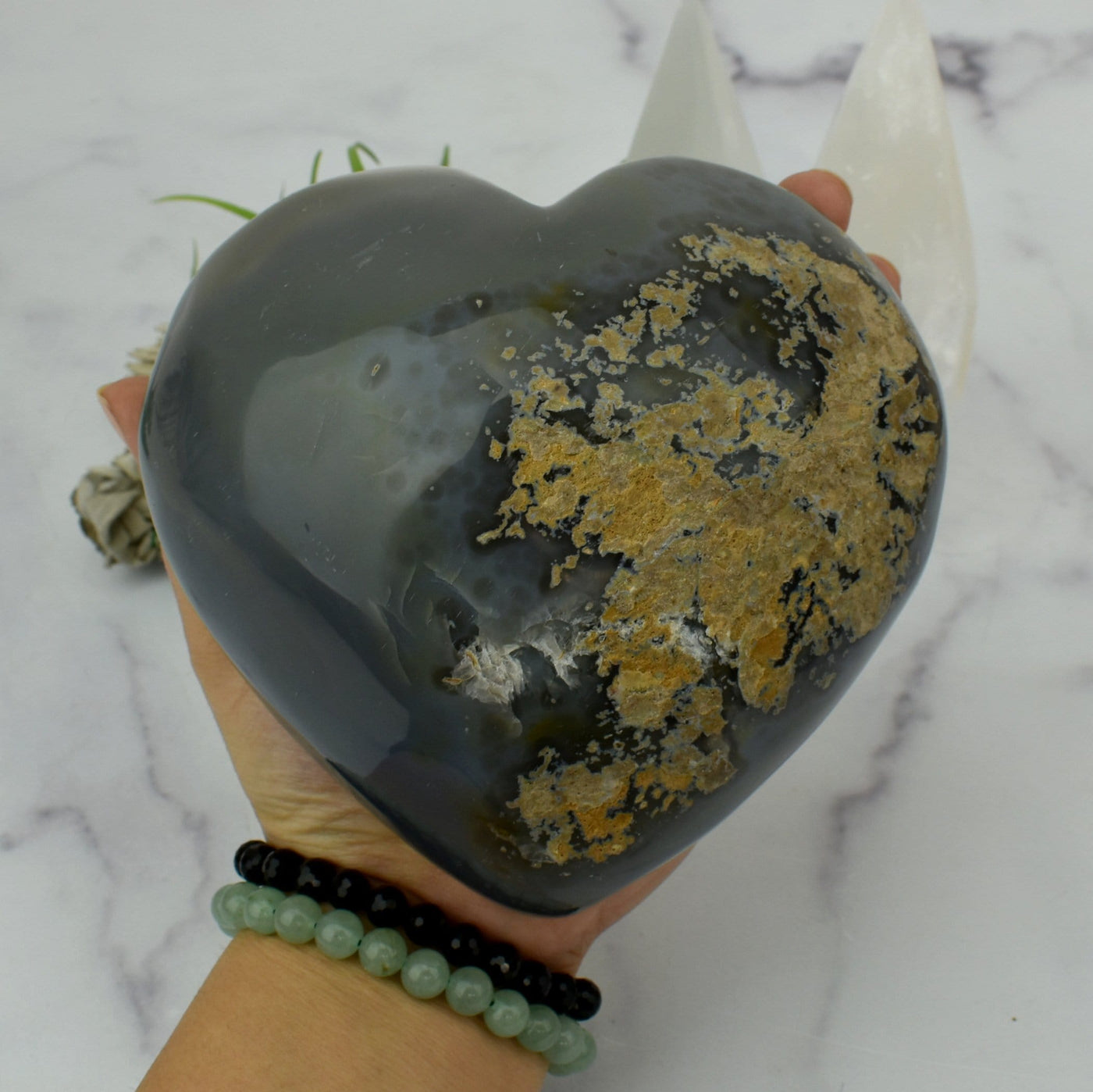 Back view of Agate Druzy Heart - OOAK - (DOOAK-S24-05) in a hand.
