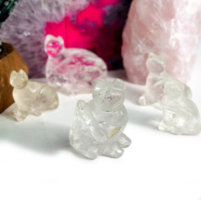 5 Crystal Quartz Cat Mini Statues with decorations in the background