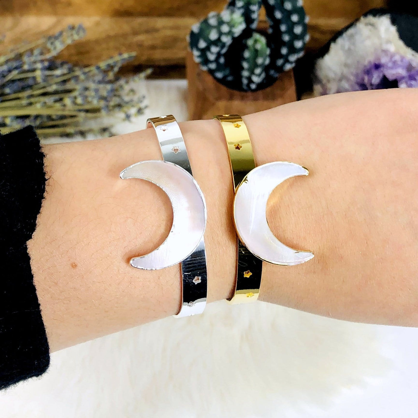 close up of moon bracelets on an arm
