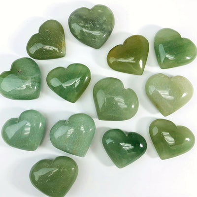 Green Aventurine Hearts scattered on white background