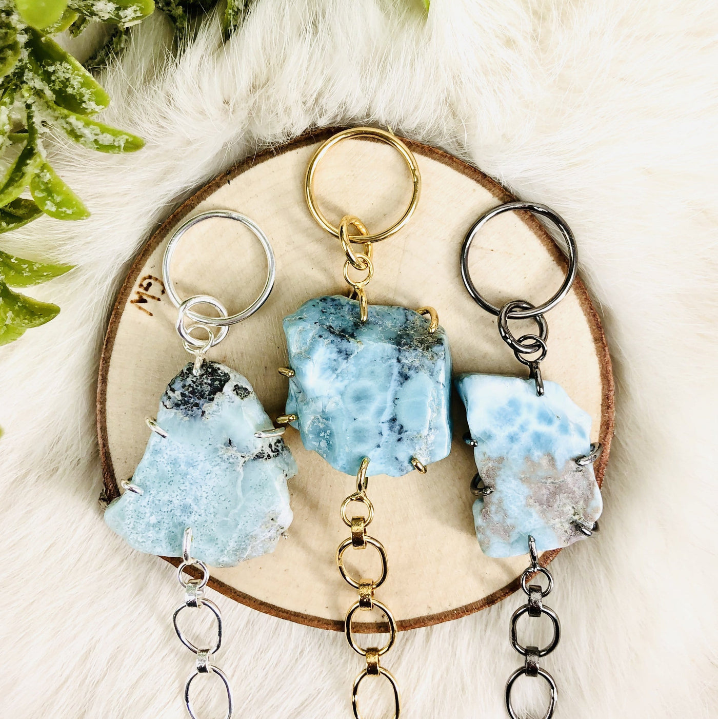 3 Larimar Bracelets in different metals with decorations in the background
