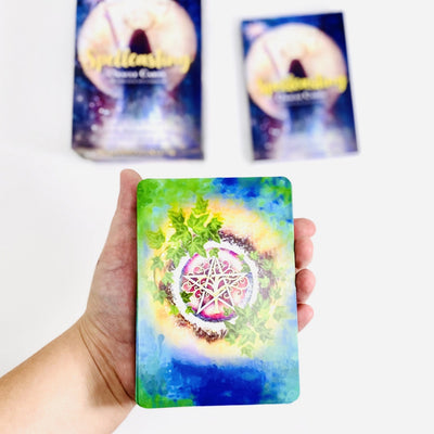 Spellcasting Oracle Card deck in hand to for size reference