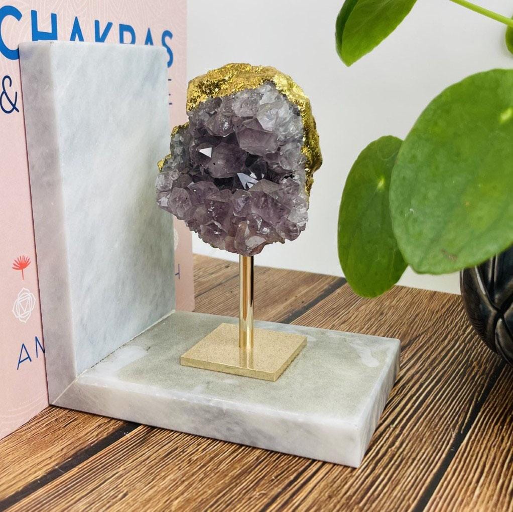close up of amethyst cluster on marble base bookend 