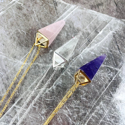 Rose Quartz Amethyst and Crystal Quartz Pendulum Necklaces in gold from the top perspective
