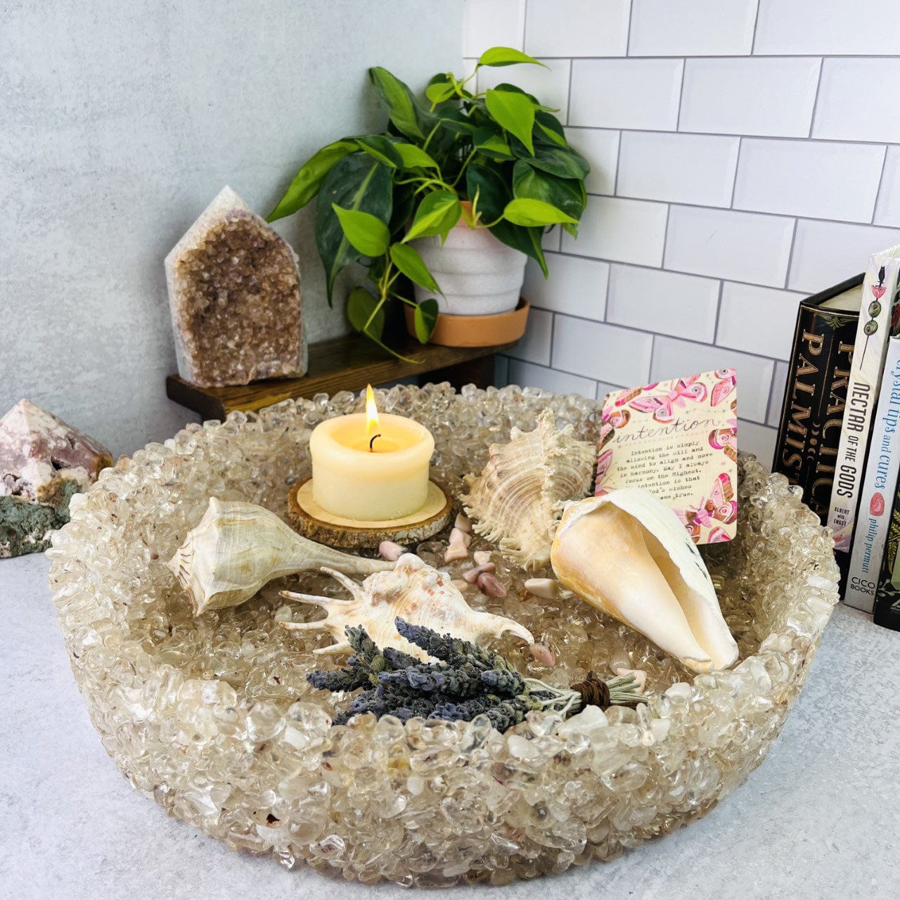 stone bowl with a candle and shells in it