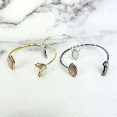 gold silver gunmetal cuffs displayed in mother of pearl to show different color hues
