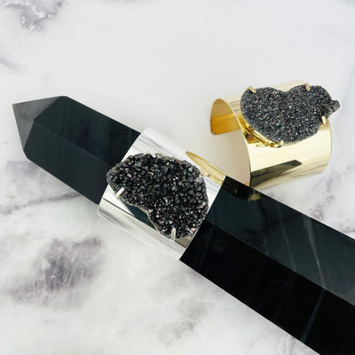 Black Diamond Titanium Druzy Bracelet with Electroplated Adjustable Cuff displayed on gemstone tower point
