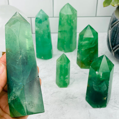 Green Fluorite Point in hand for size reference 