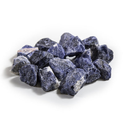 many sodalite rough stones in a pile on white background