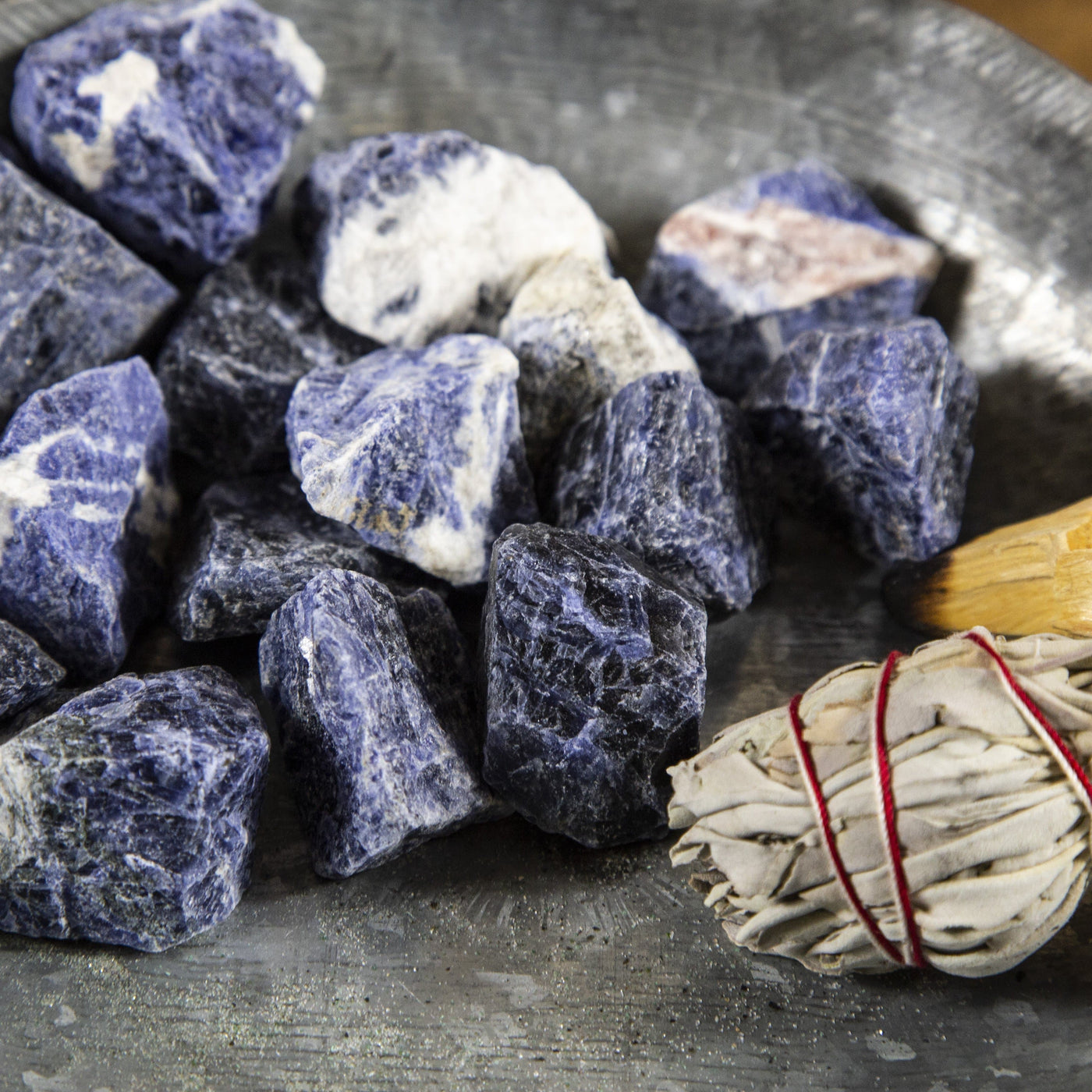 close up of many sodalite rough stones in a pile on display