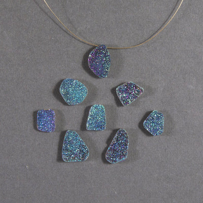 rainbow druzy beads displayed with a wire through hole and up close to view various colors textures shapes sizes