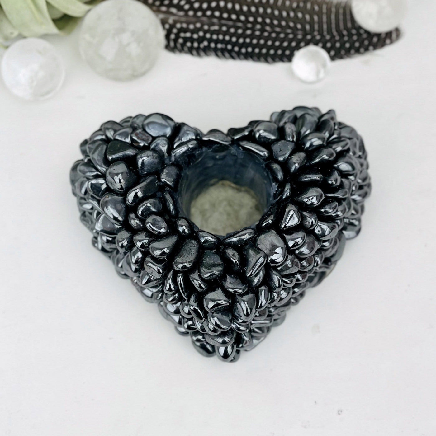hematite tumbled stone heart candle holder - close up on a table