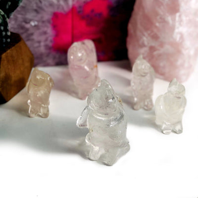 5 Crystal Quartz Cat Mini Statues with decorations in the background