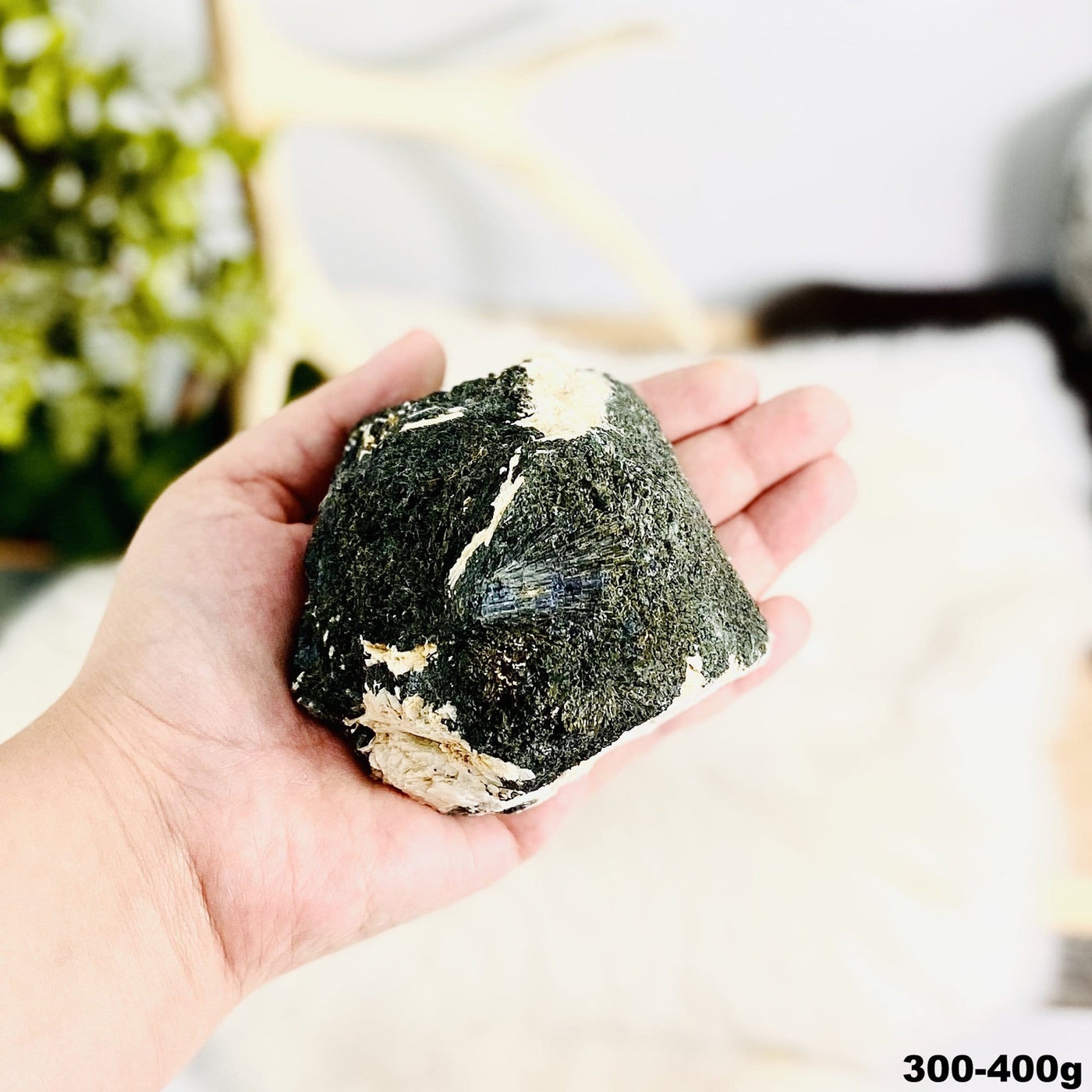 1 piece of Epidote In Quartz Chunk in hand showing the weight 300 to 400 grams on white background.