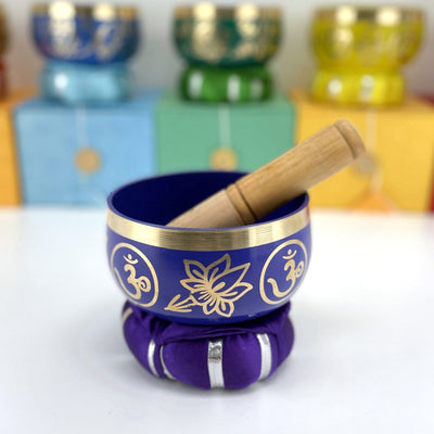 Brass Tibetan Singing Bowls - purple bowl on a table