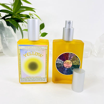 2 bottles of Gemstone Mist - Yellow Vibrational Color with decorations in the background