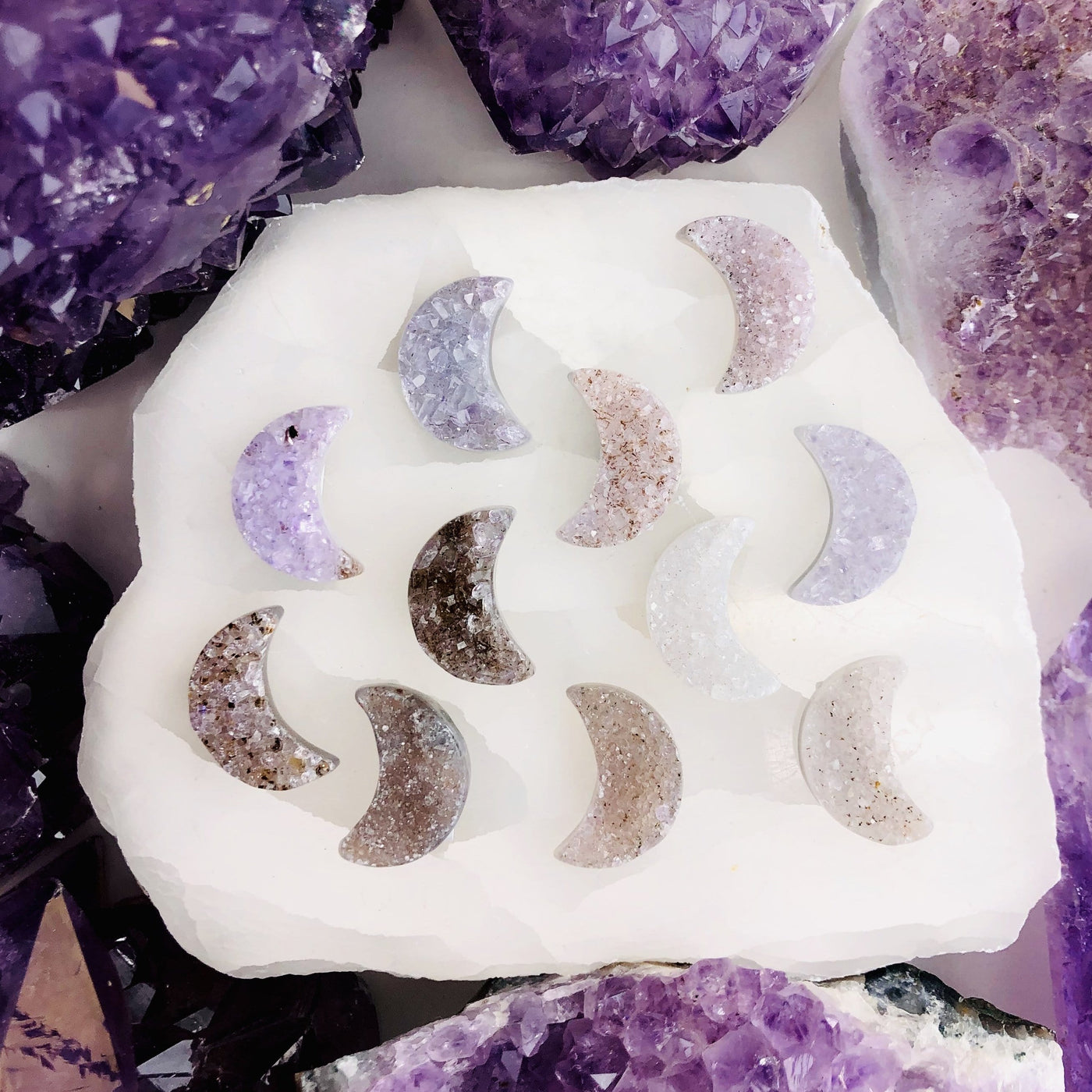 Front facing Agate Druzy Moon Cabochons (RK134B4) with a white background in an alter displaying color variation.