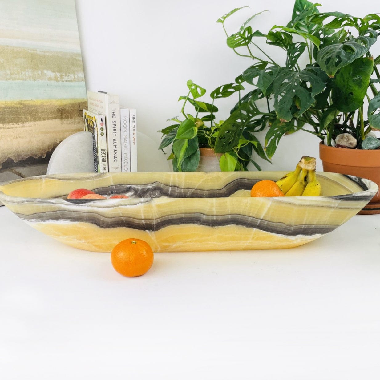Mexican Onyx Oval Bowl with fruit inside from a side view