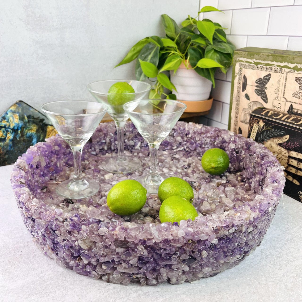 amethyst stone bowl with 3 glasses and some limes in it