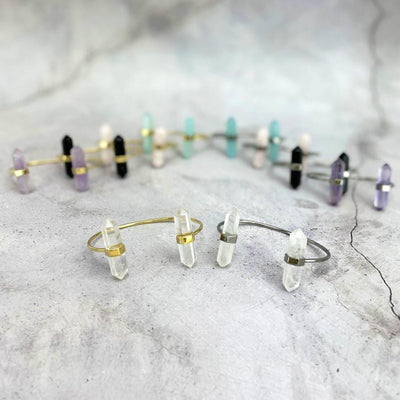 crystal quartz Crystal Point Cuffs in gold and silver with others in the background