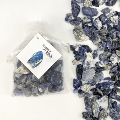 Sodalite Stones - Tied & Tagged in an Organza Bag next to stones on a table