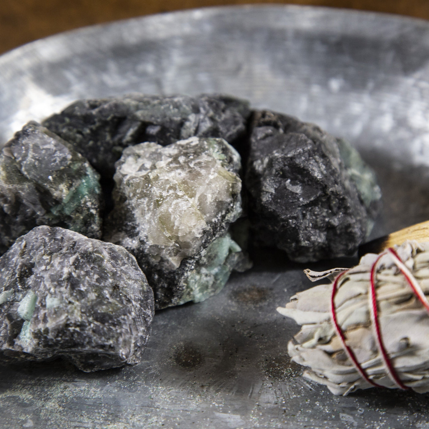 5 chunk of Emerald Rough Stones next to bundle of sage.