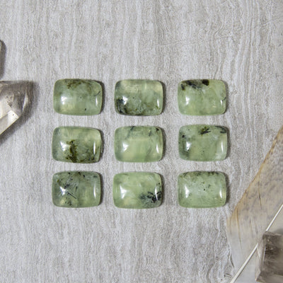 9 prehnite cabochons on gray background