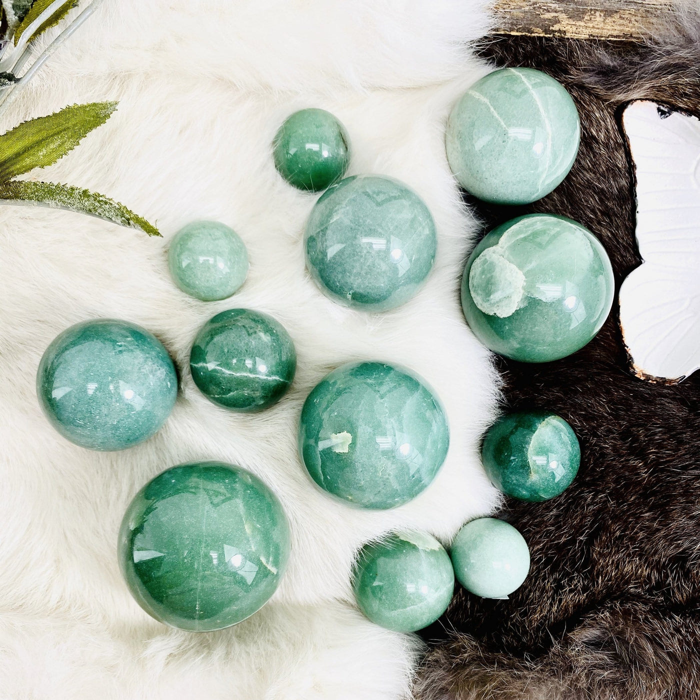 multiple green aventurine polished spheres displayed to show the differences in the sizes  