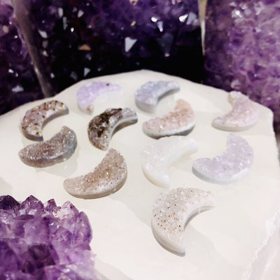 An angled view of Agate Druzy Moon Cabochons (RK134B4) in an alter.