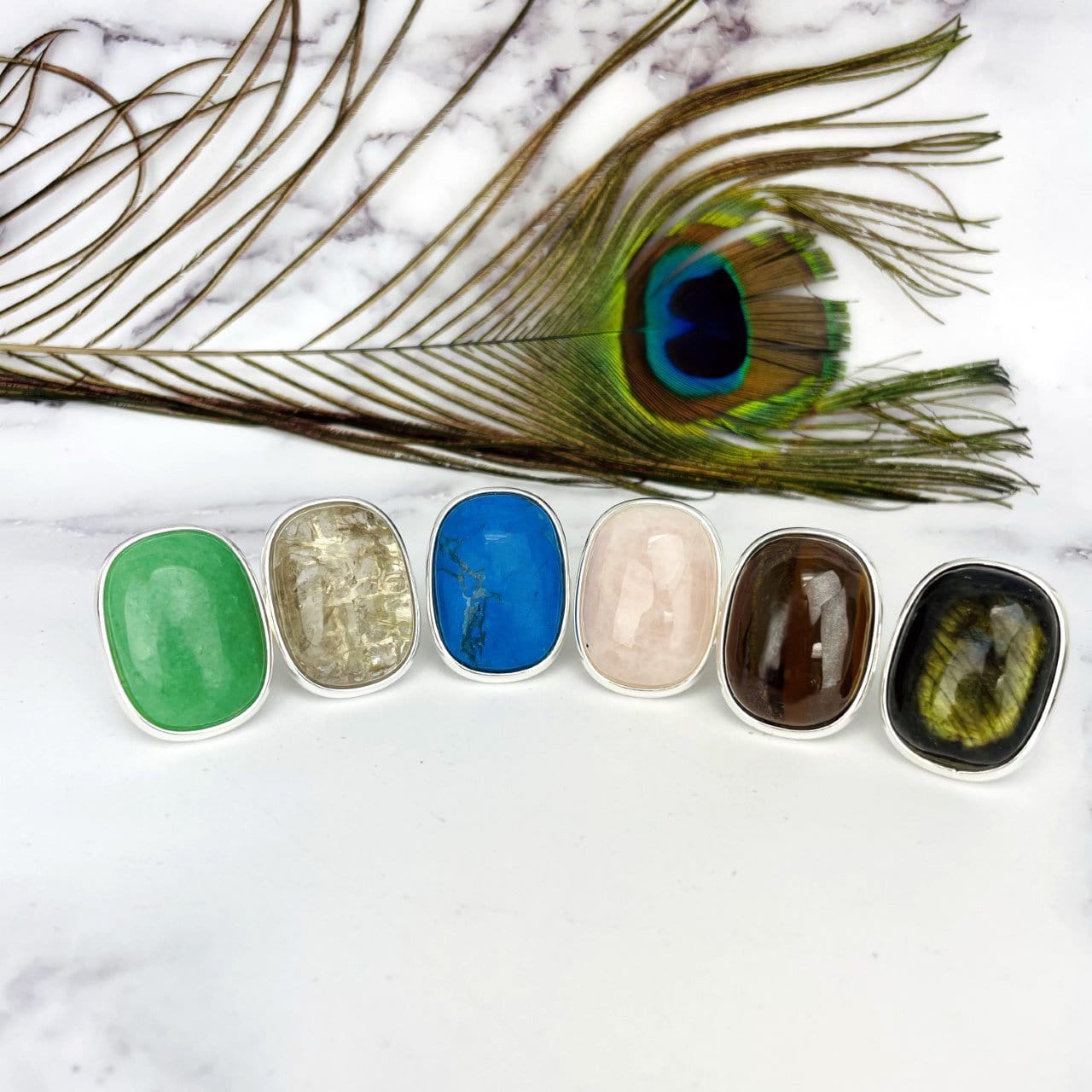 Stone Ring Polished large Oval  - 6 different stones on a table
