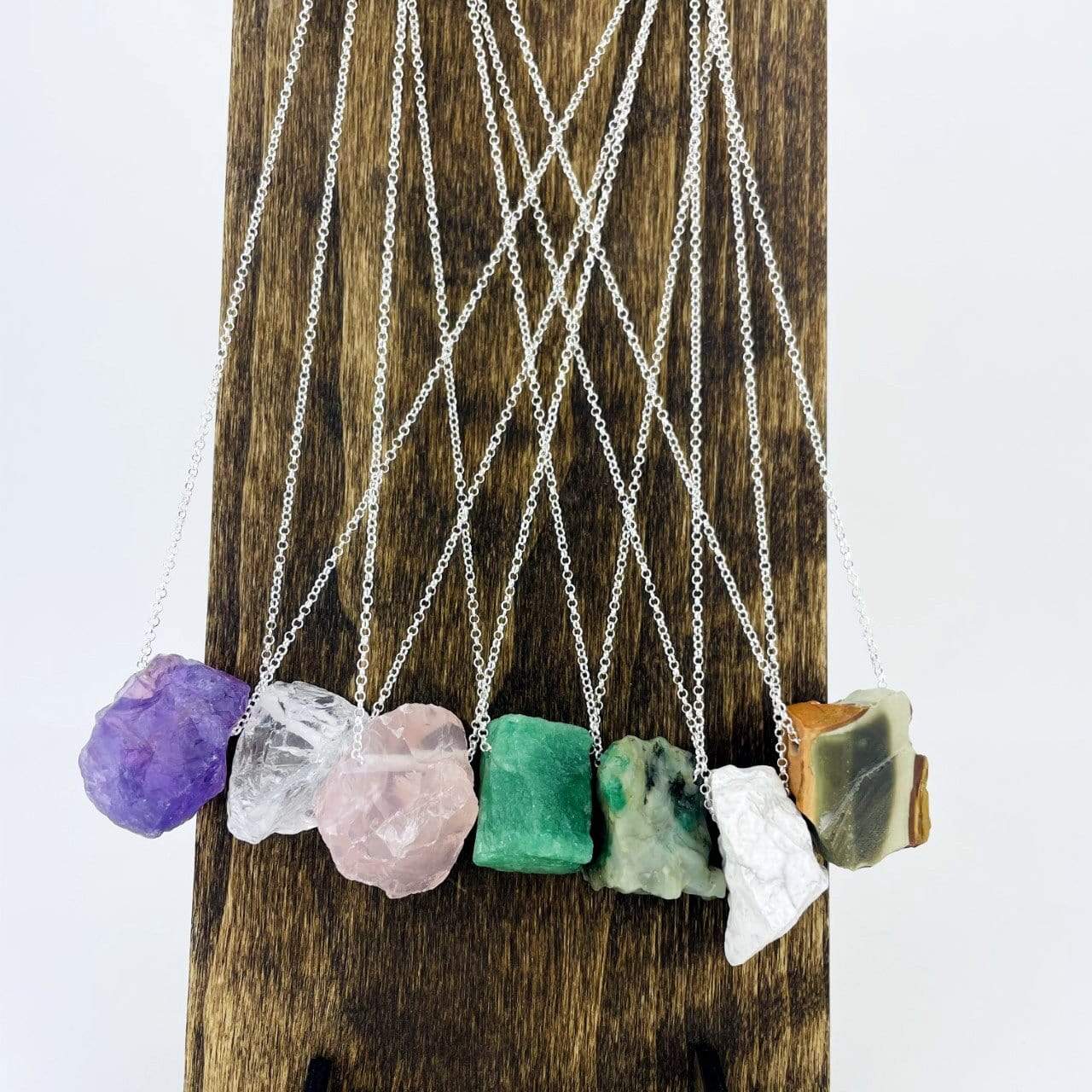 Healing Stone Necklaces with silver chain on stand
