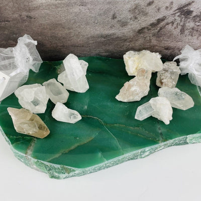 2 crystal bag sets laid out on a green slab 