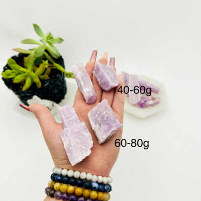  RAW KUNZITE - BY WEIGHT - four rocks in hand showing size for weights 40-60g and 60-80g 