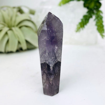 Amethyst Polished Point with decorations in the background