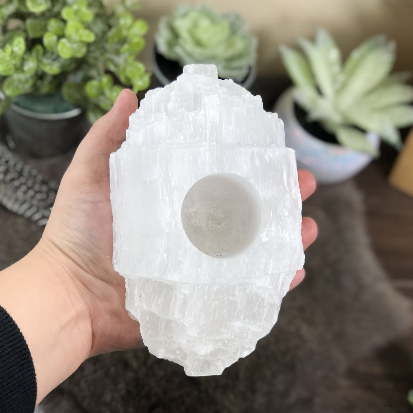 selenite log candle holder in hand for size reference