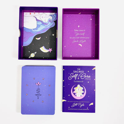 A 55-card deck and guidebook. Carddeck box is open , has a saying on there "Take care of yourself so you can shine your souls light" . 