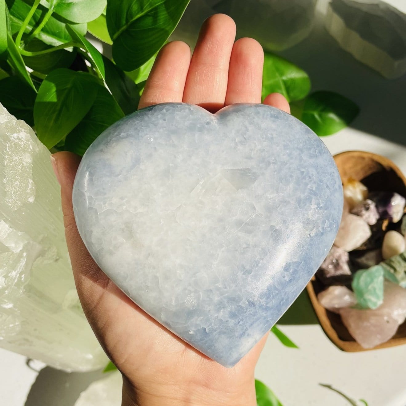 Blue Calcite Heart in a hand for size reference