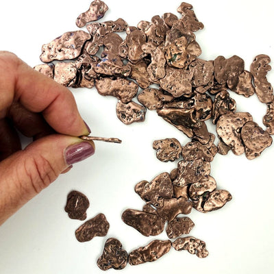 Copper Nuggets - Freeform Shapes with one in a hand showing nugget thickness