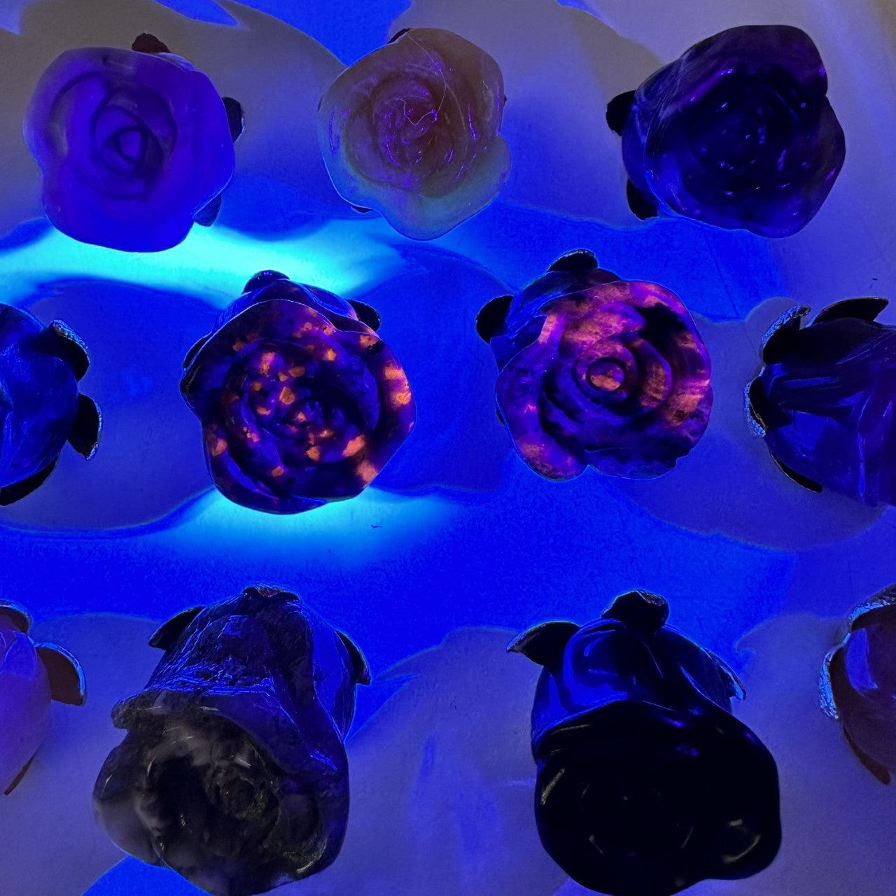 Crystal Rose - Carved Stones under black light - yooperlite and sodalite react!