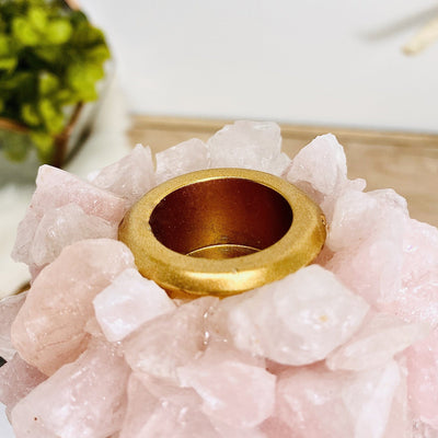 Top view of Rose Quartz Taper Candle Holder with decorations blurred in the background