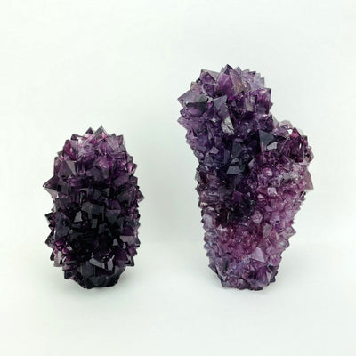 small and large purple salt crystal formation on display for size comparison