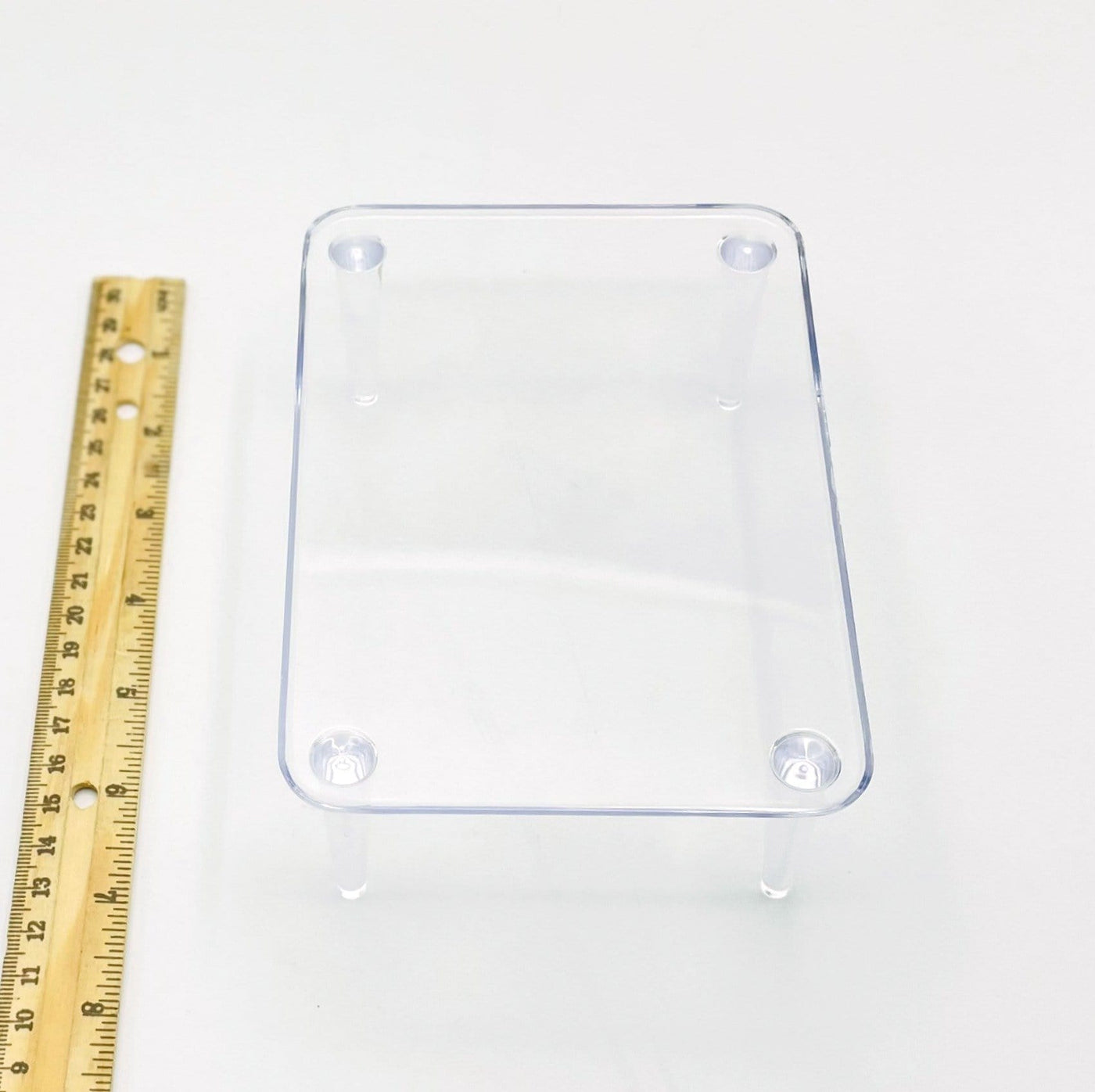 crystal display stand next to a ruler for size reference 