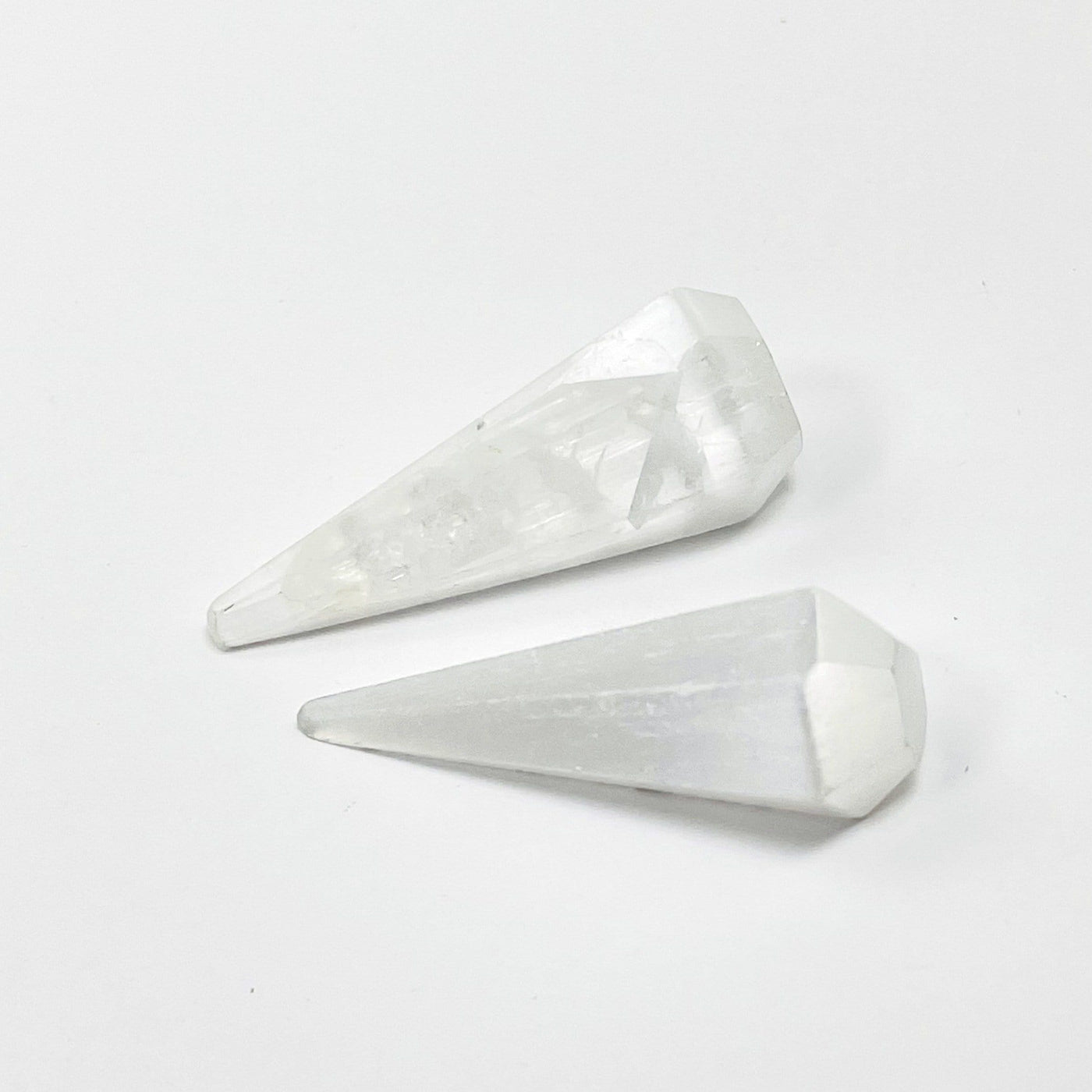 close up of two selenite pendulum points for details